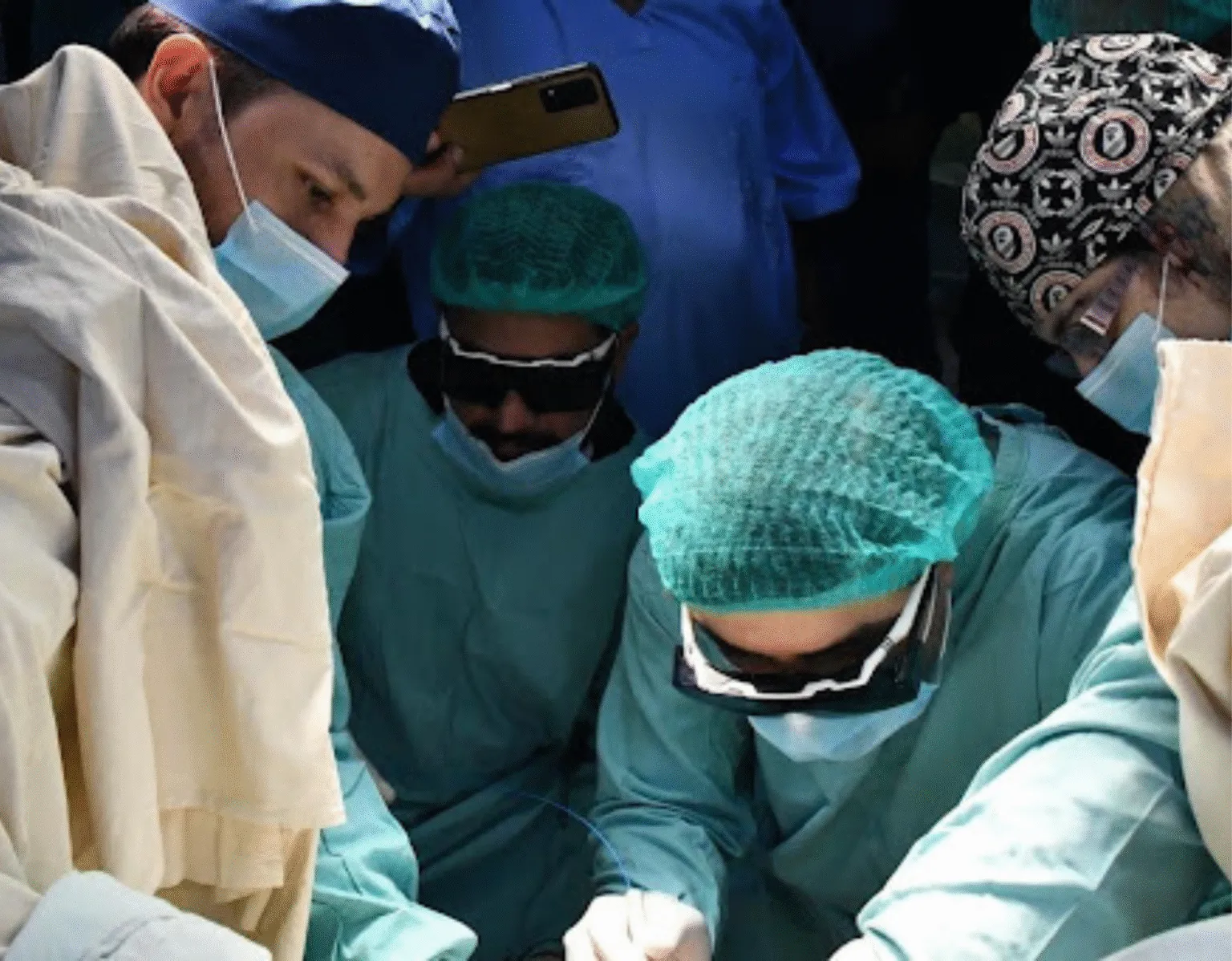 Experienced surgeons performing advanced surgical procedure in operation theatre