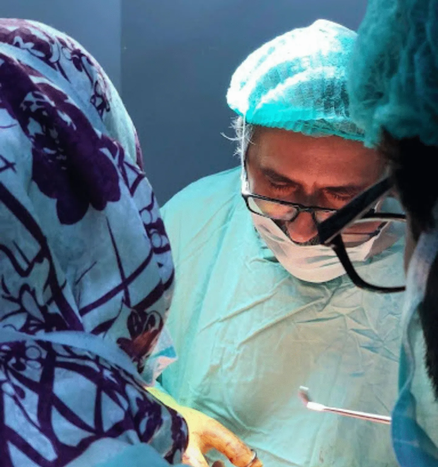 Senior surgeon performing delicate surgical procedure in operation theatre