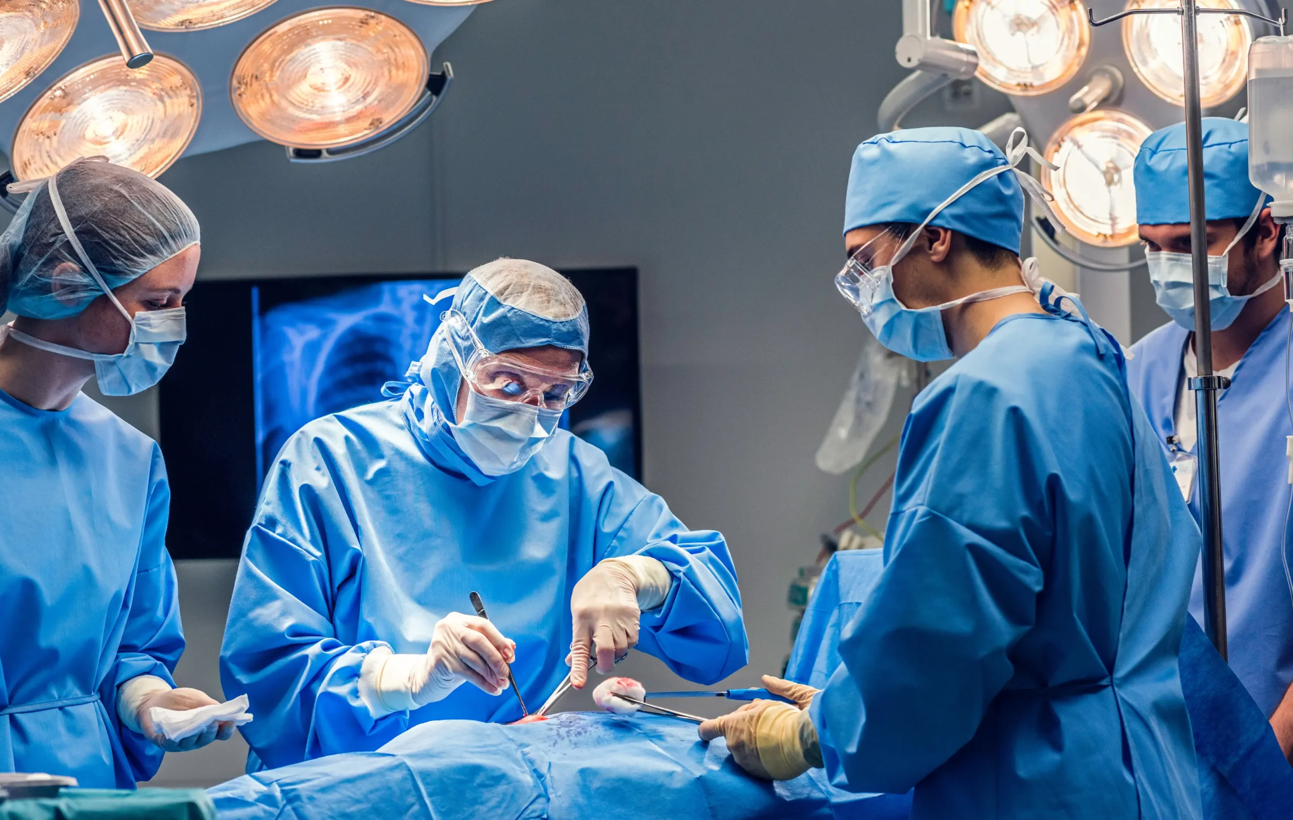 Surgical team performing procedure in operation theatre